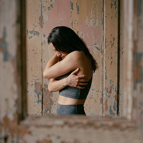 Woman holding her shoulder